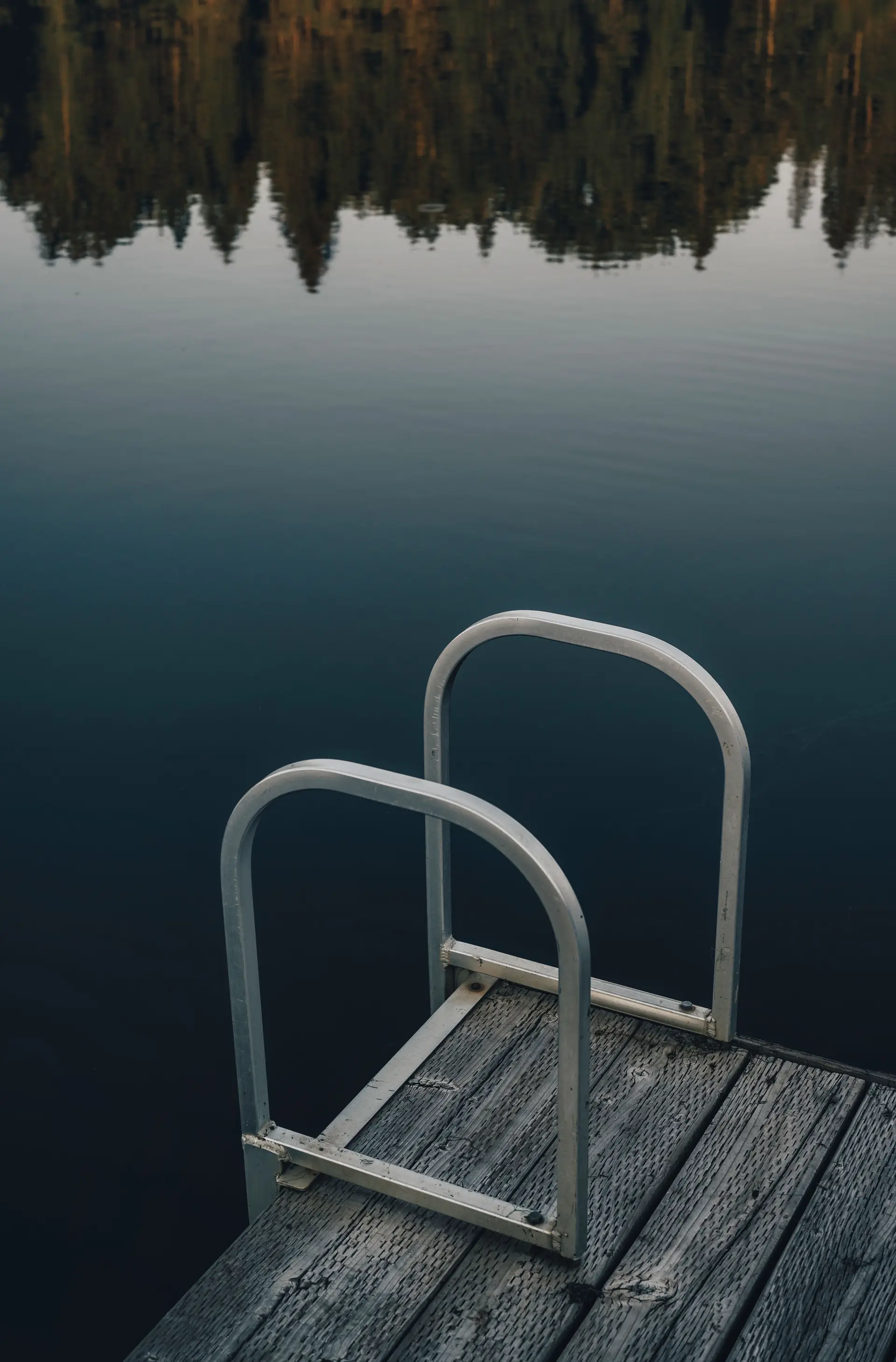 Secluded wooden dock jutting into still Canadian waters