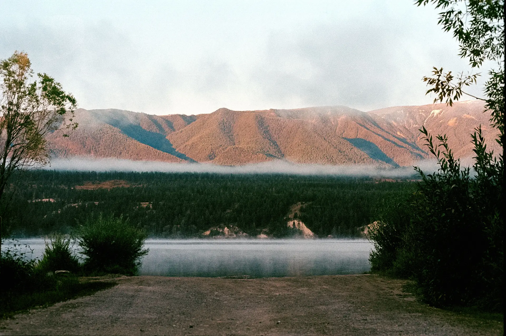 Misty dawn over a calm Canadian lake