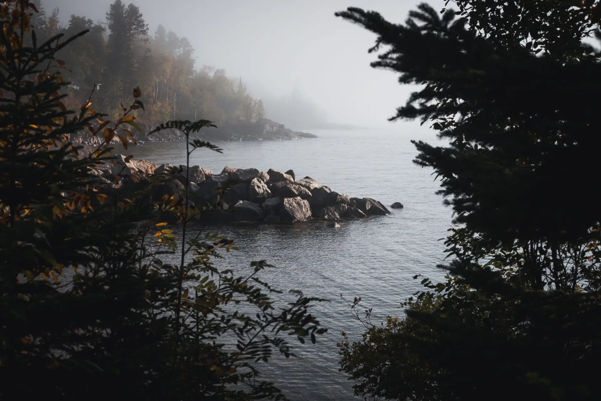 Rocky Canadian shoreline framing quiet lake waters