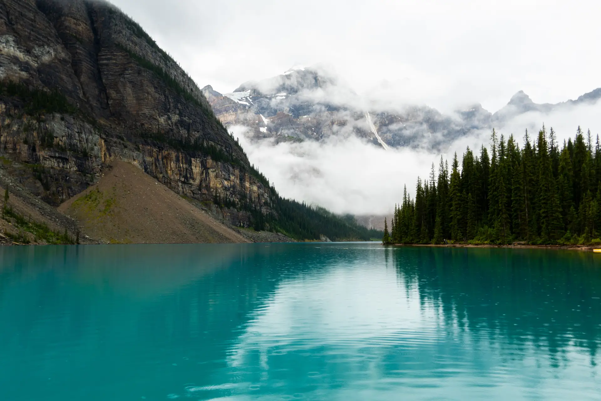 Clear crystal blue Canadian waters surrounded by lush summer pines